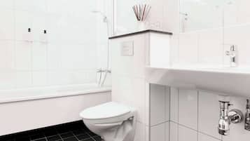 Un baño moderno con inodoro blanco, bañera y lavabo.