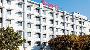 A modern hotel building with a prominent "Scandic" sign, multiple windows, and a structured facade. - Scandic Västerås (Vasteras)