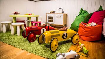 Children can play and snack in this inviting space with a kitchenette and play area.