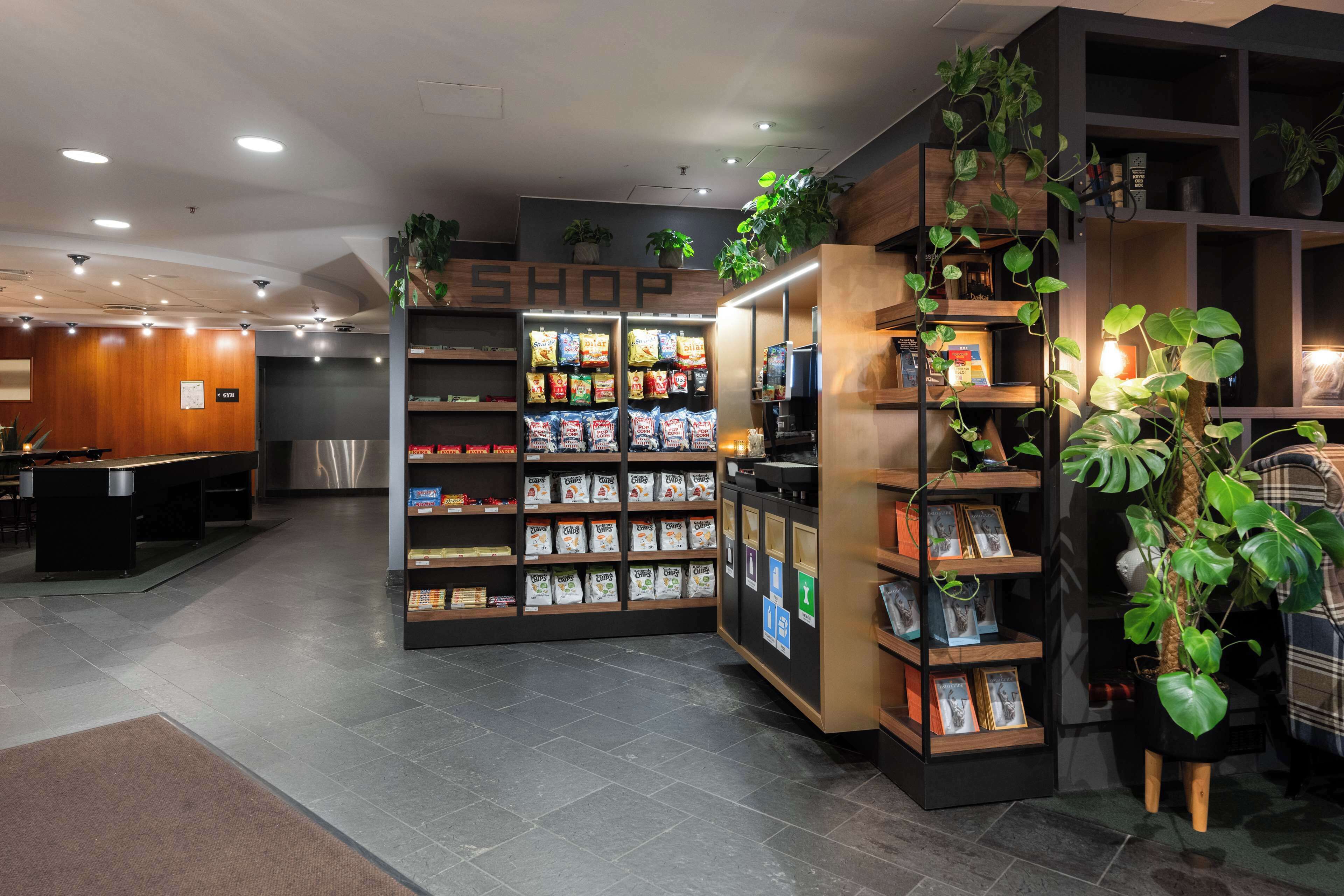 A modern retail shop with shelves stocked with snacks and a variety of products.
