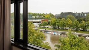 Overlooking a tranquil waterway, this room offers a serene view of boats and a blend of modern and traditional architecture.