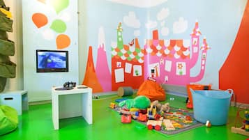Children can play and create in this colorful space with a table for digital activities, a bean bag chair, and plenty of toys.