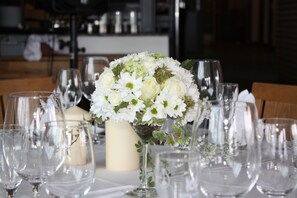 A table set for a formal event with a centerpiece of white flowers and candles. - Scandic Solli Oslo (Oslo)