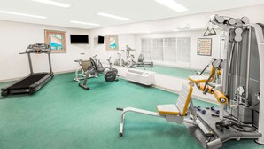 A gym with treadmills, stationary bikes, and weight machines.