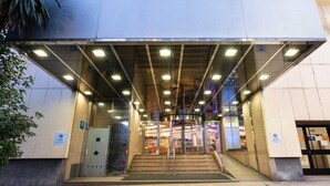 A modern building entrance with a covered staircase leading to the ground floor. - Exe Coruña (A Coruña)