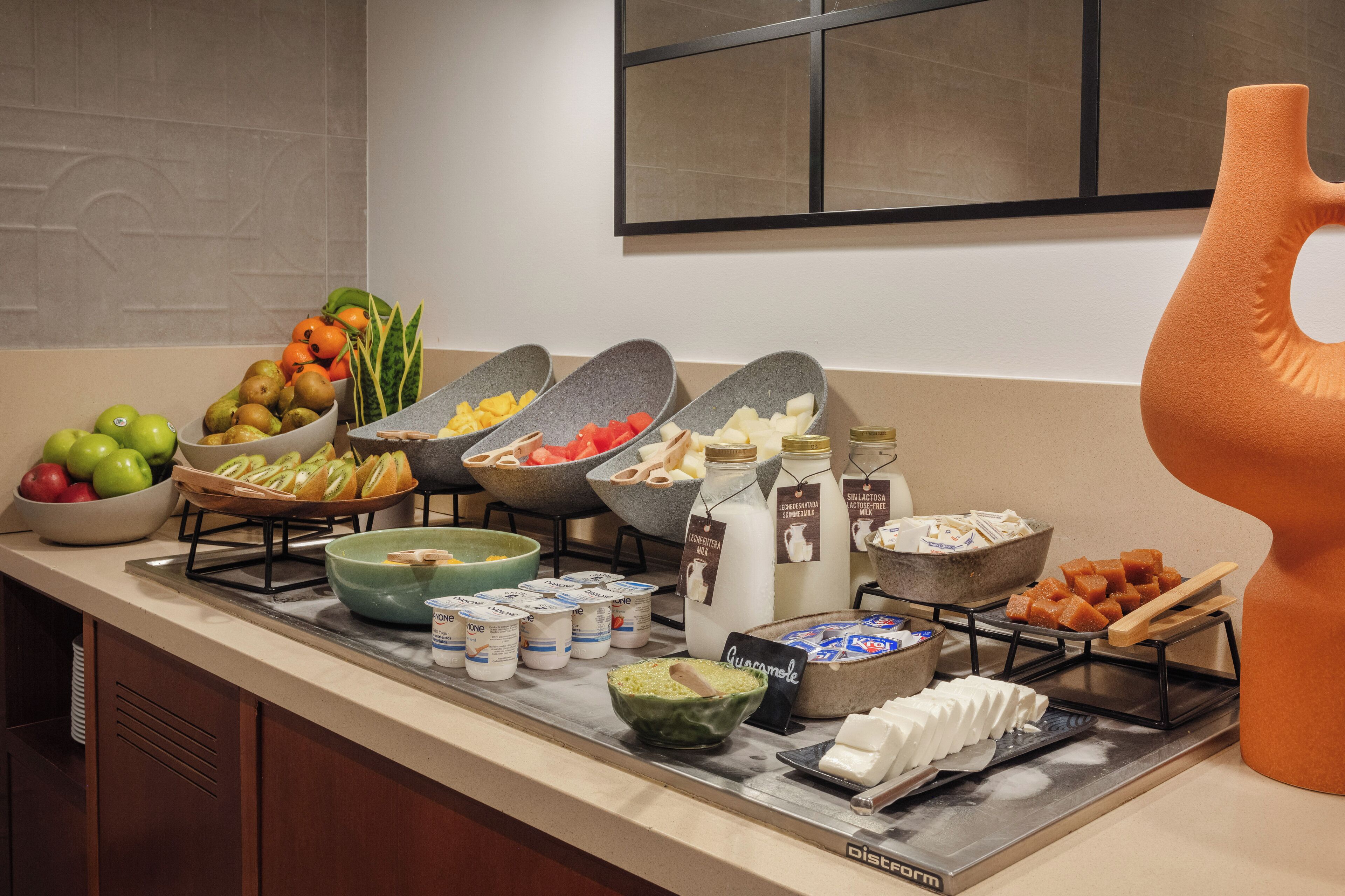 A buffet setup with various food items and containers.