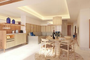 Una cocina moderna con armarios de madera, una alacena para vinos empotrada y un comedor con una mesa redonda y sillas.