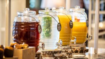 A beverage station with multiple dispensers, each labeled with a different drink.