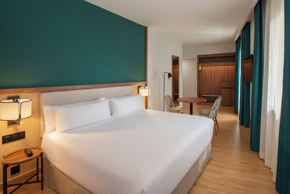 Superior Room | Minibar, in-room safe, desk, iron/ironing board