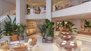 A spacious, multi-level hotel lobby with high ceilings, modern furnishings, and abundant indoor plants. - Paradisus by Meliá Fuerteventura – All Inclusive (Pajara)