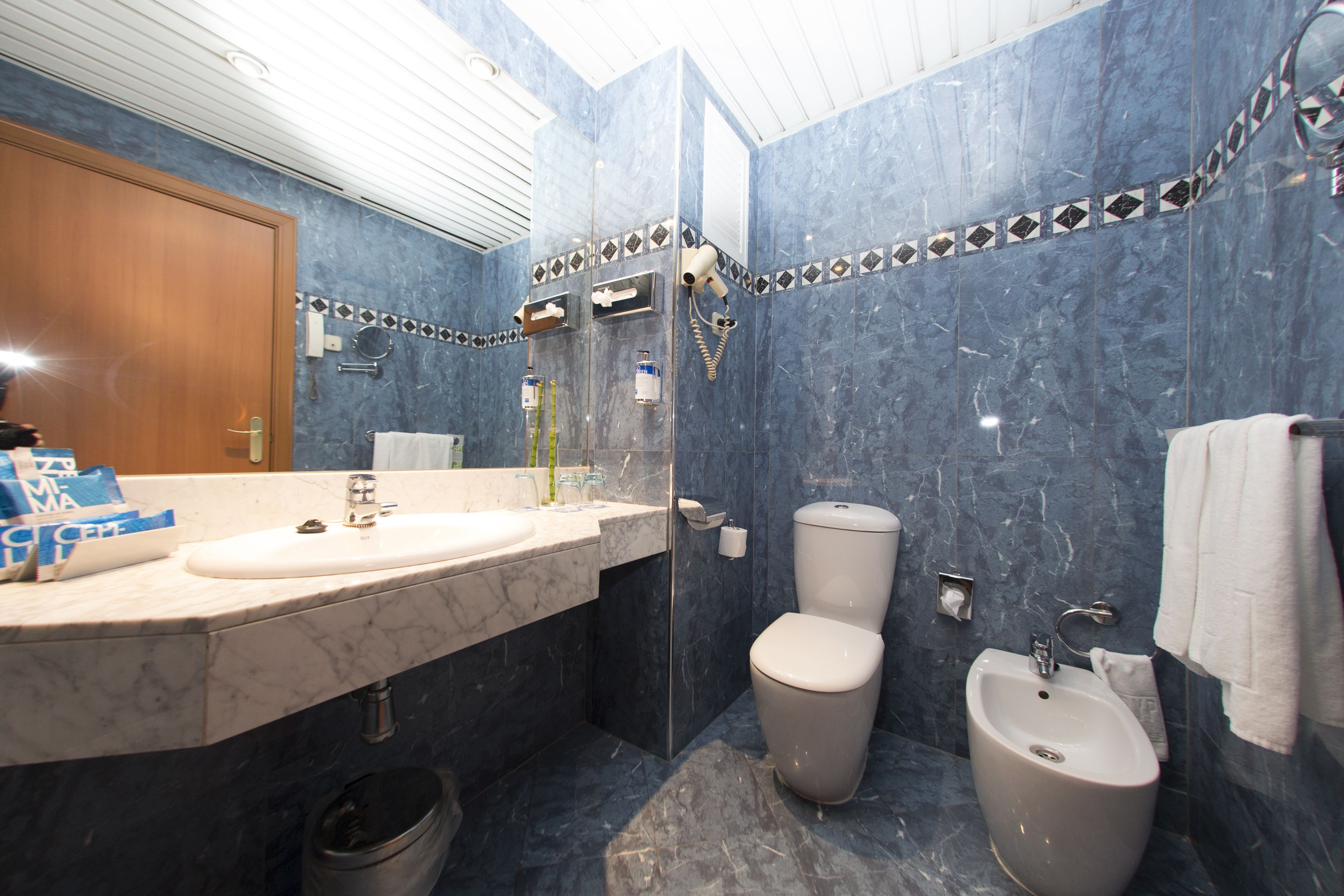 eco-friendly toiletries, hair dryer, towels