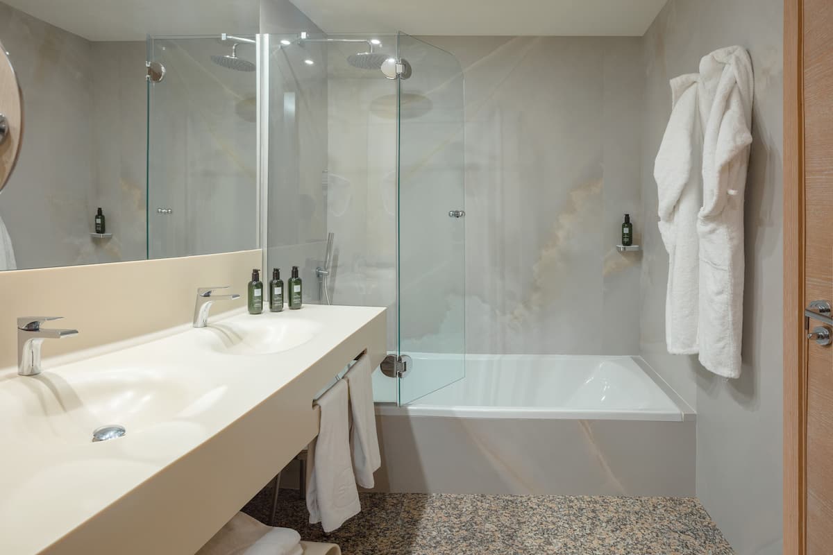 designer toiletries, hair dryer, bathrobes, slippers