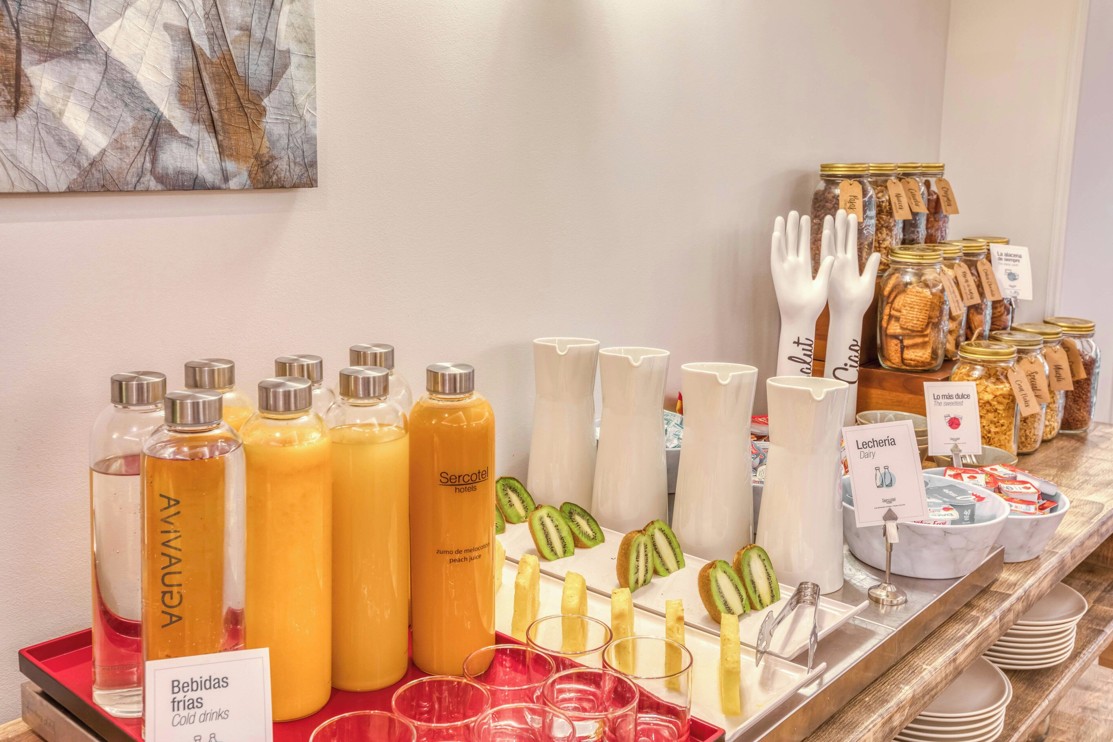 A breakfast buffet with various food items and beverages.