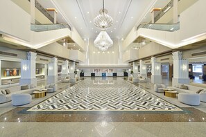 A spacious lobby with a geometric patterned floor, modern lighting, and a central chandelier. - Twin Towers Hotel (Bangkok)