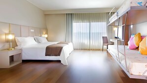 A hotel room with a bed, bedside tables, a chair, a desk, and a bunk bed. - TRYP by Wyndham Porto Expo Hotel (Matosinhos)