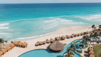On the beach, white sand, beach umbrellas, beach towels