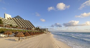 On the beach, white sand, beach umbrellas, beach towels