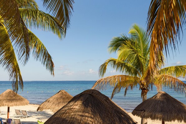 On the beach, white sand, sun-loungers, beach umbrellas