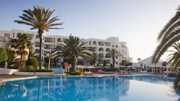 Indoor pool, outdoor pool, open 8 AM to 6 PM, pool umbrellas