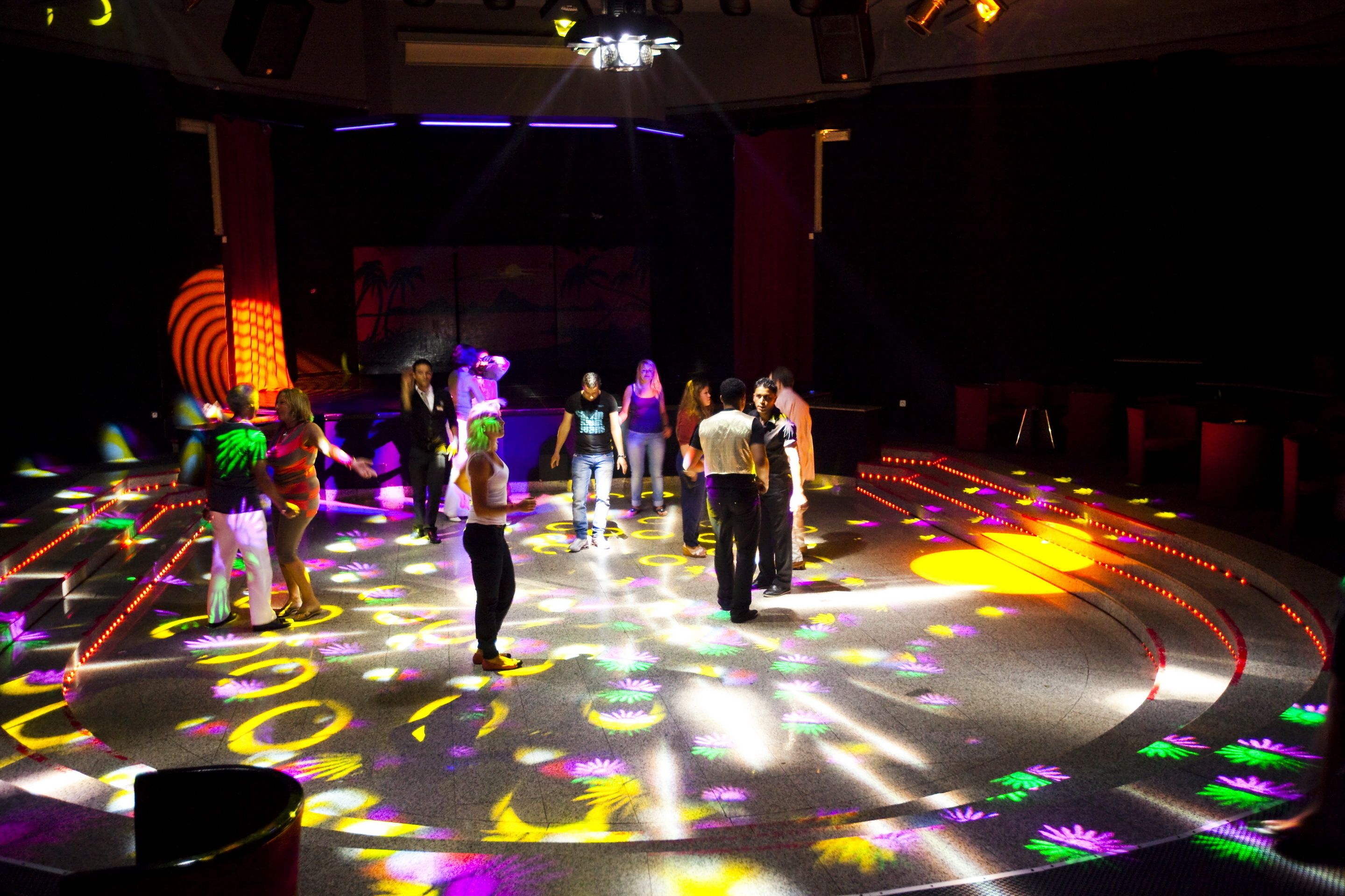 A stage with a circular platform and audience seated around it.