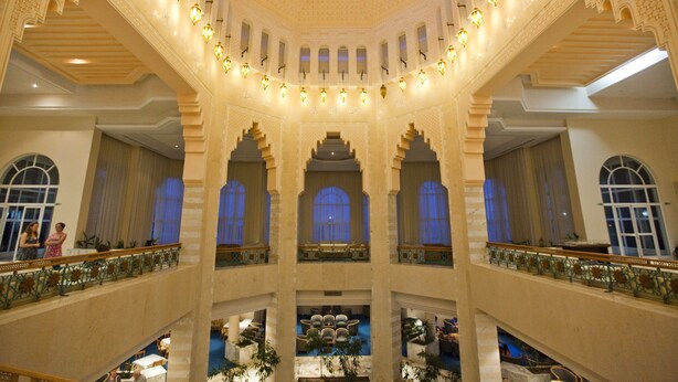 A grand interior with multiple levels, ornate arches, and a central skylight. - El Mouradi Mahdia (Mahdia)