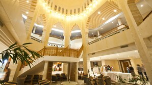 A multi-level atrium with a central open space, columns, and a staircase. - El Mouradi Mahdia (Mahdia)