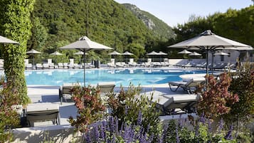 Seasonal outdoor pool, open 10:00 AM to 6:00 PM, pool umbrellas