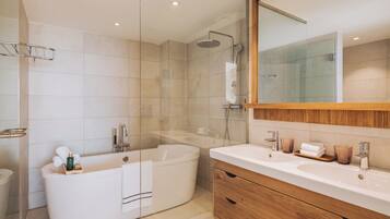 A modern bathroom with a freestanding bathtub, a glass-enclosed shower, and a wooden vanity with a sink and mirror.