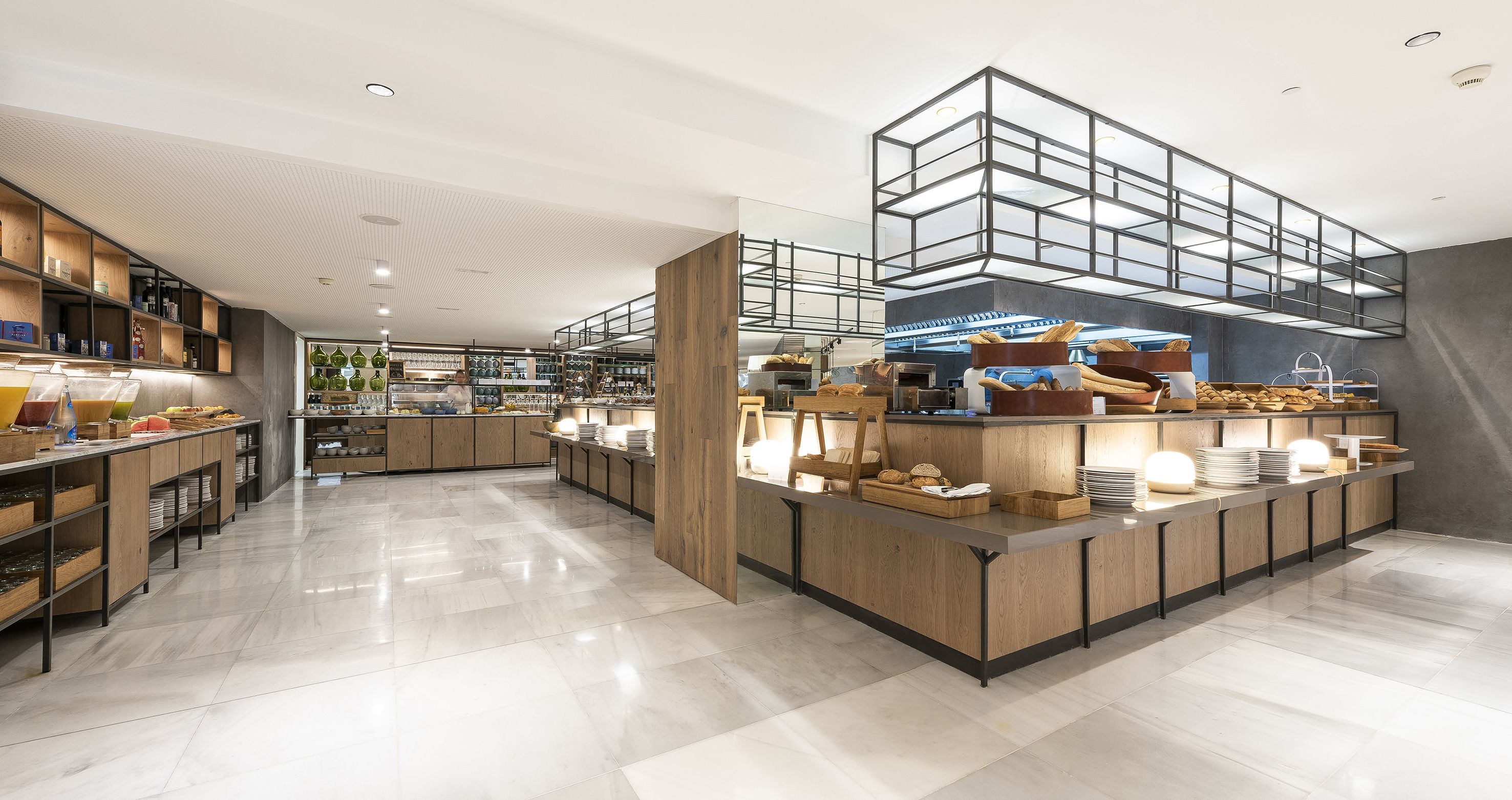 A modern, well-lit cafe with a clean, tiled floor and wooden accents.