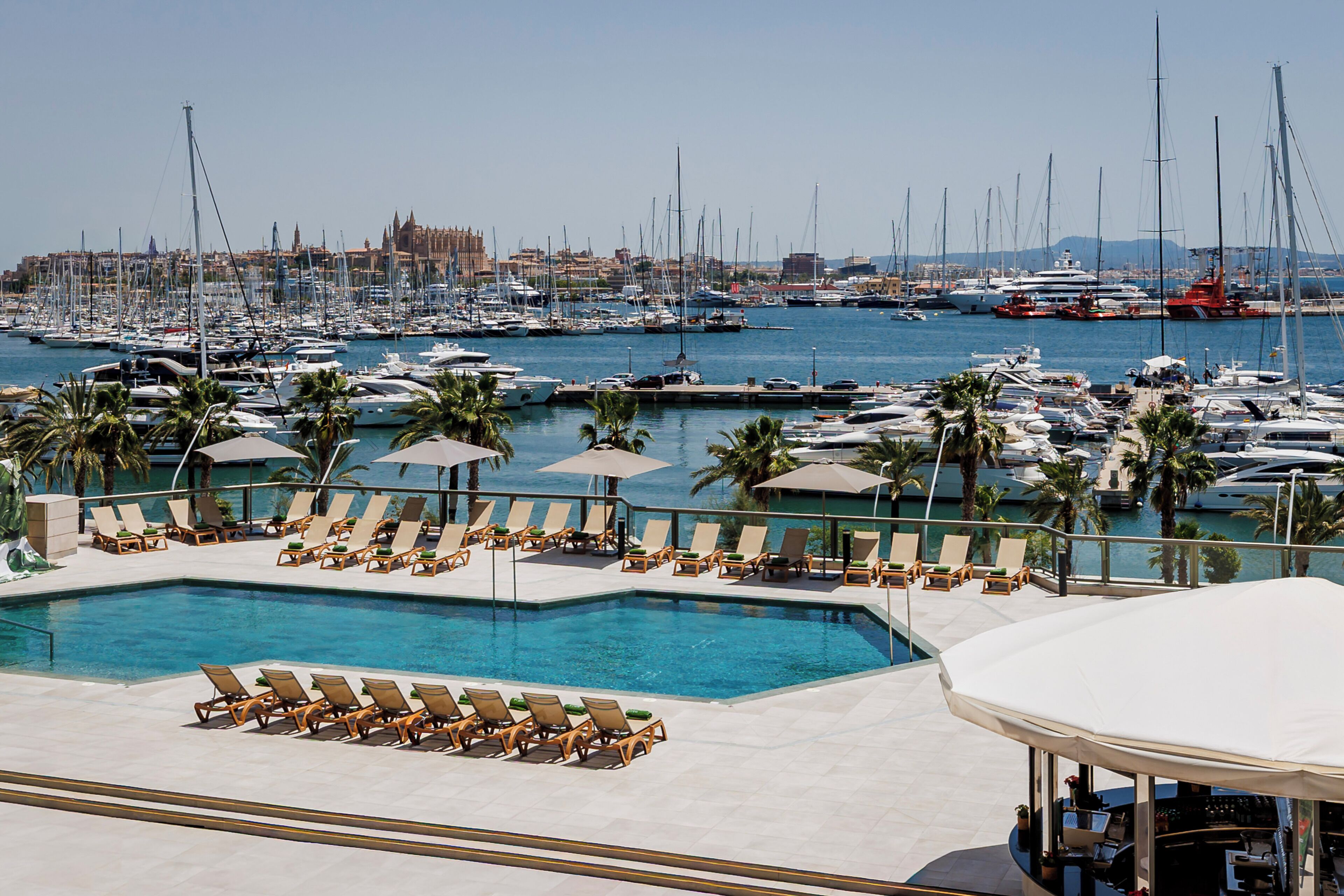 Seasonal outdoor pool, open 10:00 AM to 6:00 PM, pool umbrellas