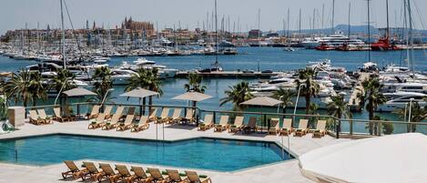 Seasonal outdoor pool, open 10:00 AM to 6:00 PM, pool umbrellas