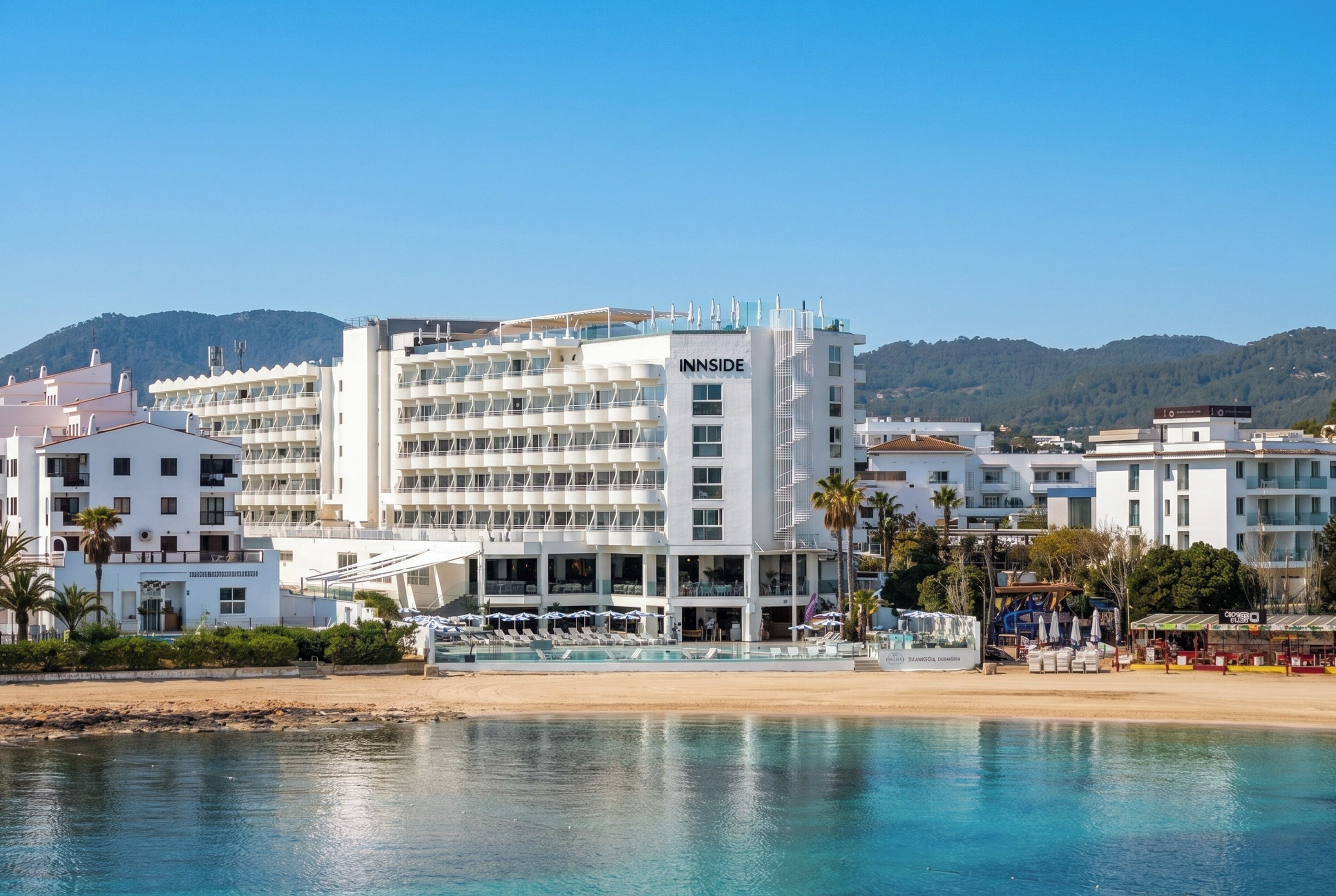 A hotel with multiple floors, a pool area, and a beach view.