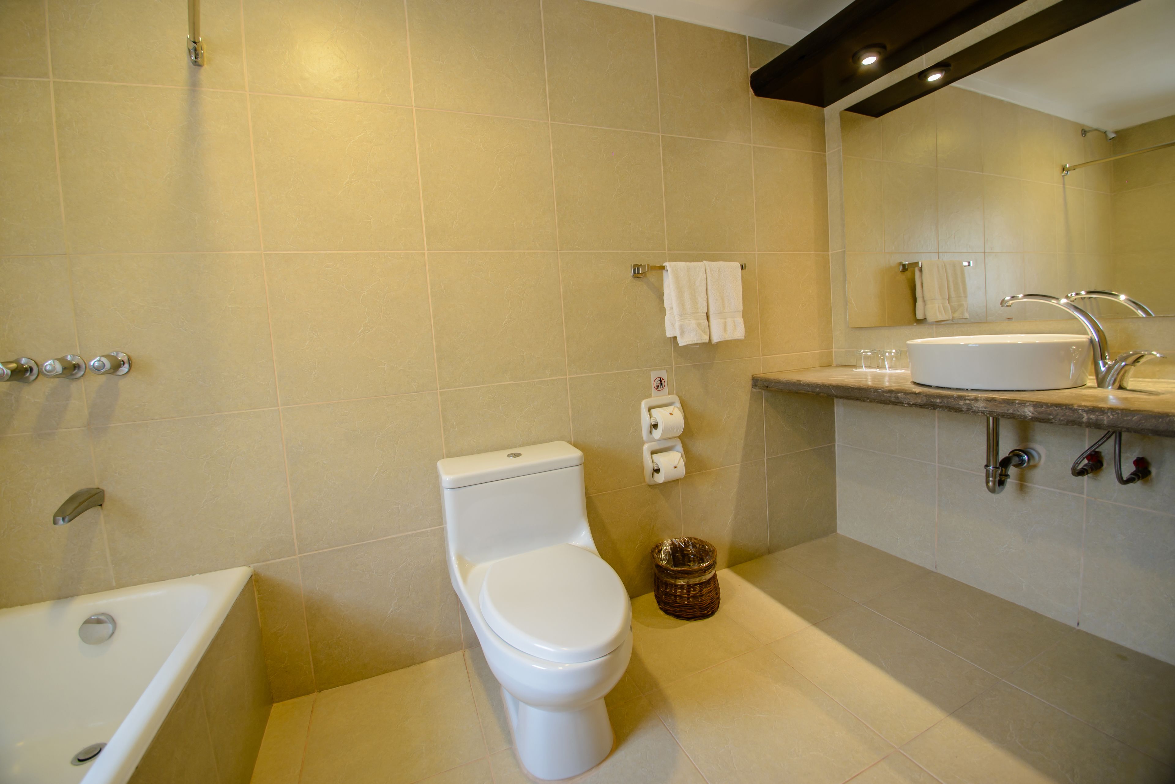 A bathroom with a toilet, sink, and bathtub.