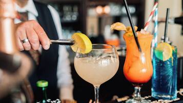 A bartender preparing a drink with a lemon garnish.