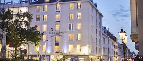 A multi-story hotel with a prominent sign reading "DAS CARLS" on the facade.