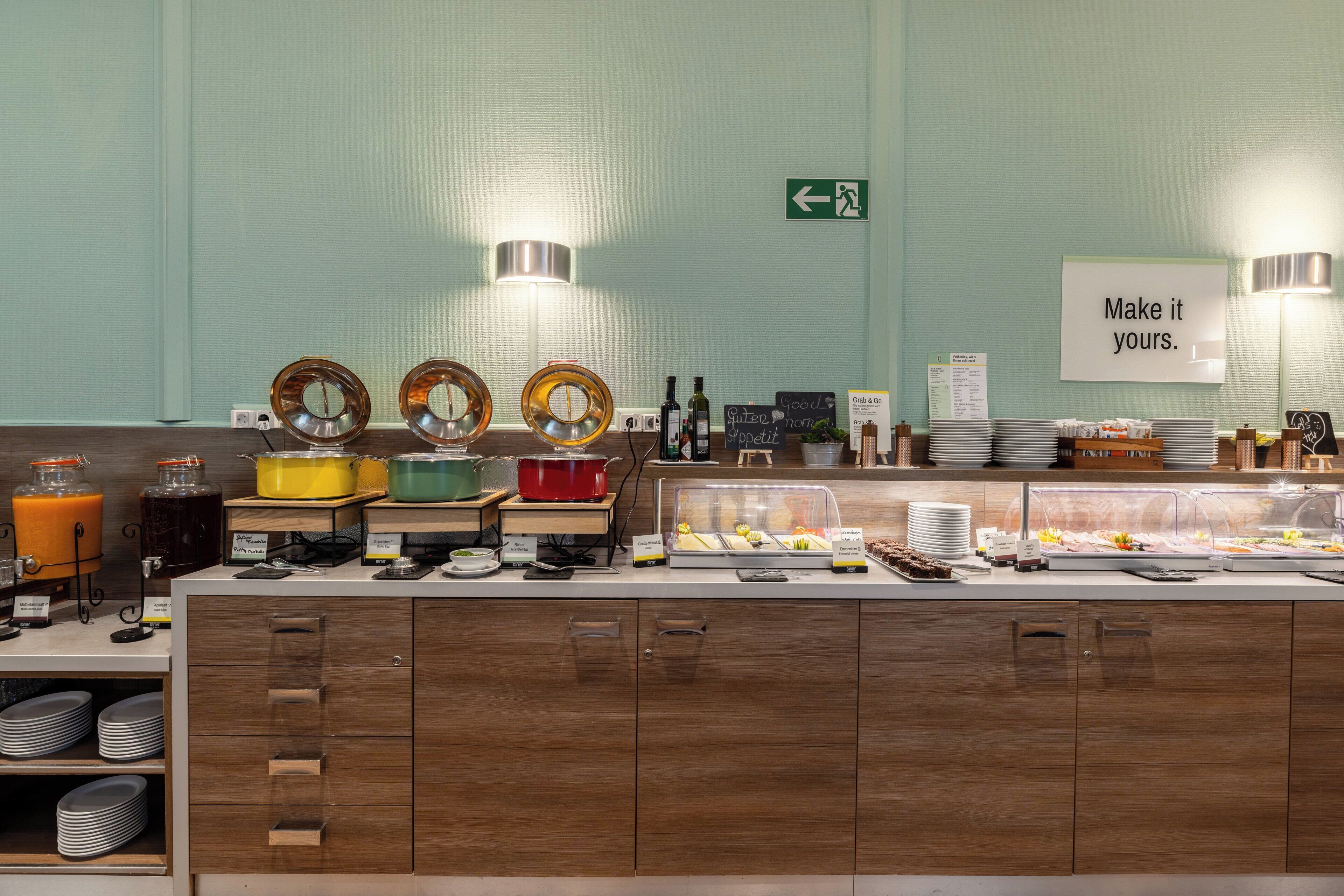 A buffet area with various food stations, including a fruit display and a salad bar.