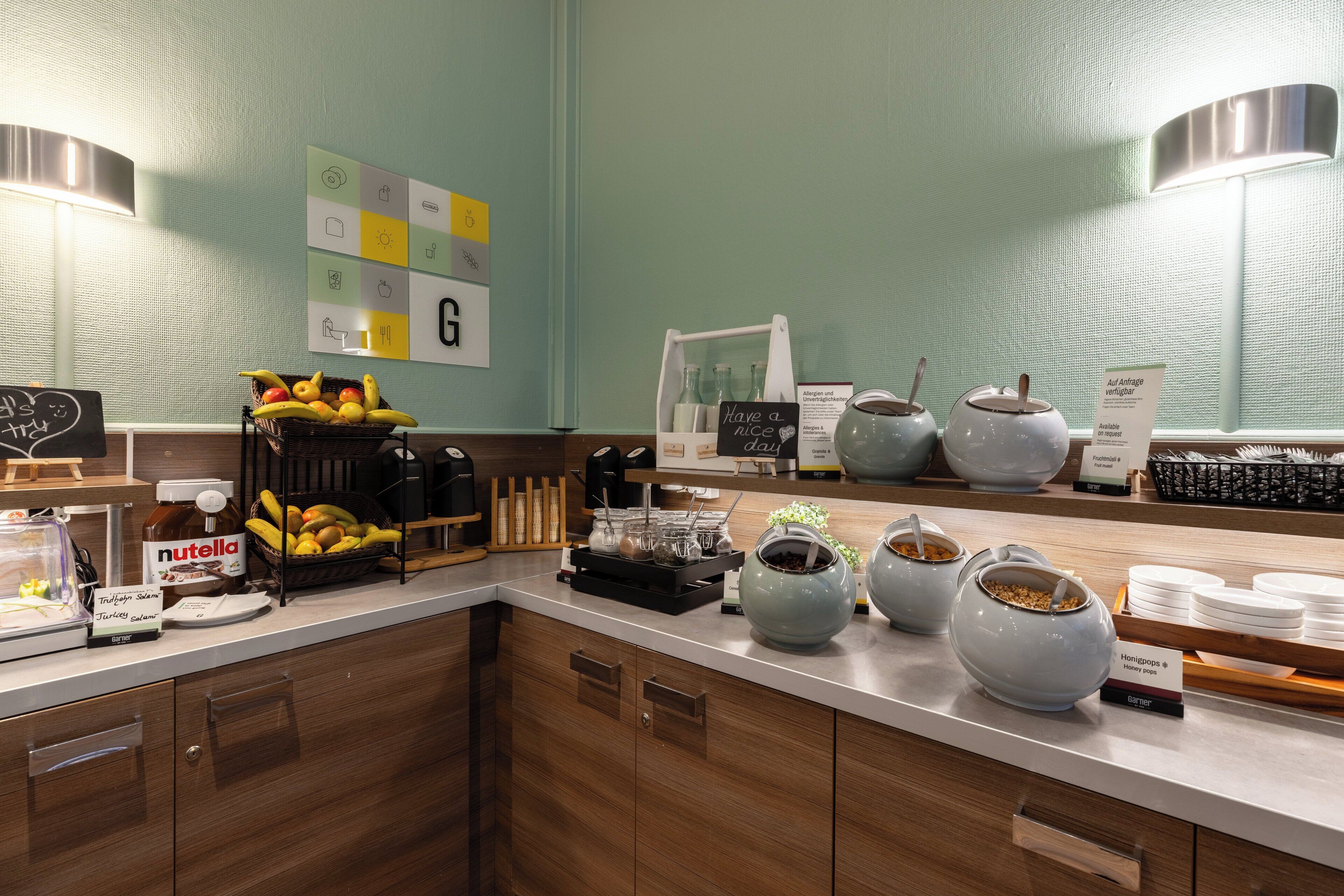 A buffet area with a variety of food items, including fruits, condiments, and beverages.
