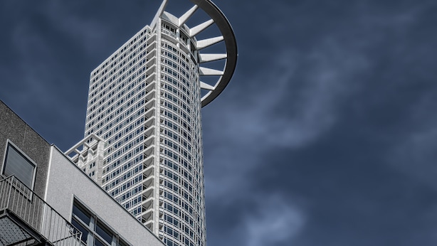 A tall building with a distinctive circular architectural feature at the top. - Mercure Hotel Frankfurt City Messe (Frankfurt)
