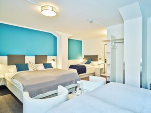 Premium bedding, desk, laptop workspace, blackout drapes