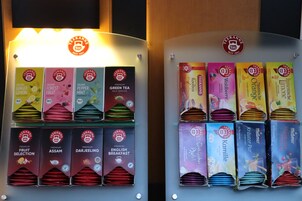 A display of various tea boxes with labels indicating different flavors and types.