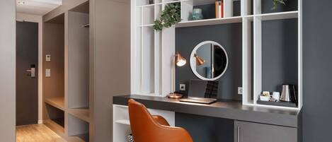 A modern office space with a desk, chair, shelves, and a mirror.