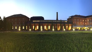 A large, historic building with multiple wings and a central courtyard.