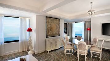 Luxury Suite | Living area | 43-inch LED TV with cable channels, TV