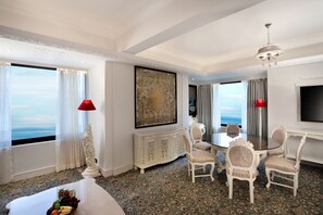 Luxury Suite | Living area | 43-inch LED TV with cable channels, TV