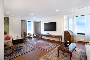 Luxury Suite | Living area | 43-inch LED TV with cable channels, TV