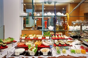 A buffet with various food stations and glassware.