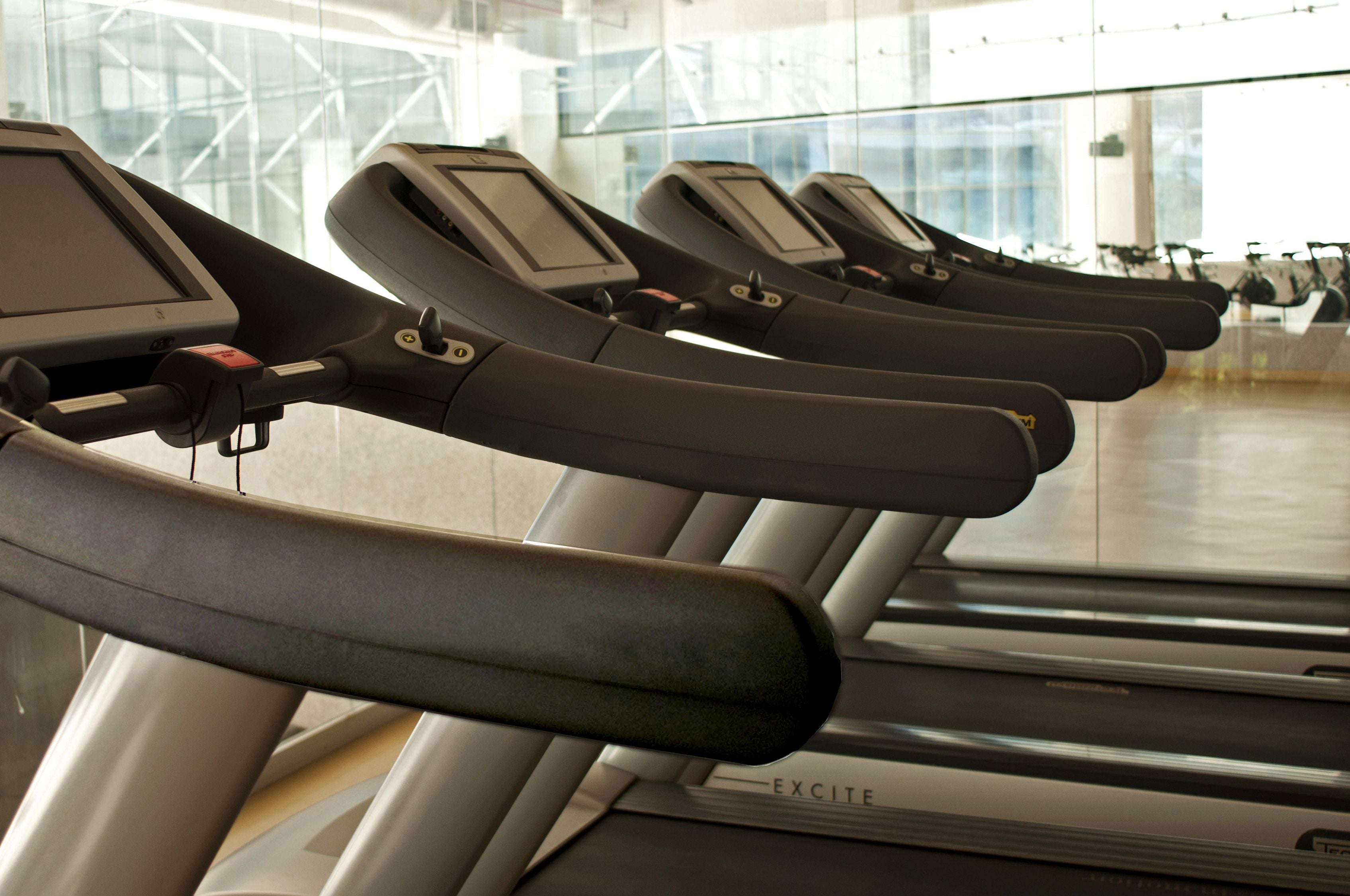 A row of stationary bikes with digital displays, likely in a gym or fitness center.