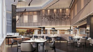 A modern restaurant with high ceilings, exposed ductwork, and a central bar area. - Petaling Jaya Marriott Hotel (Petaling Jaya)