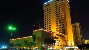 A tall hotel building with a sign reading "Safi International Hotel". - Safir International Hotel Kuwait (Kuwait City)