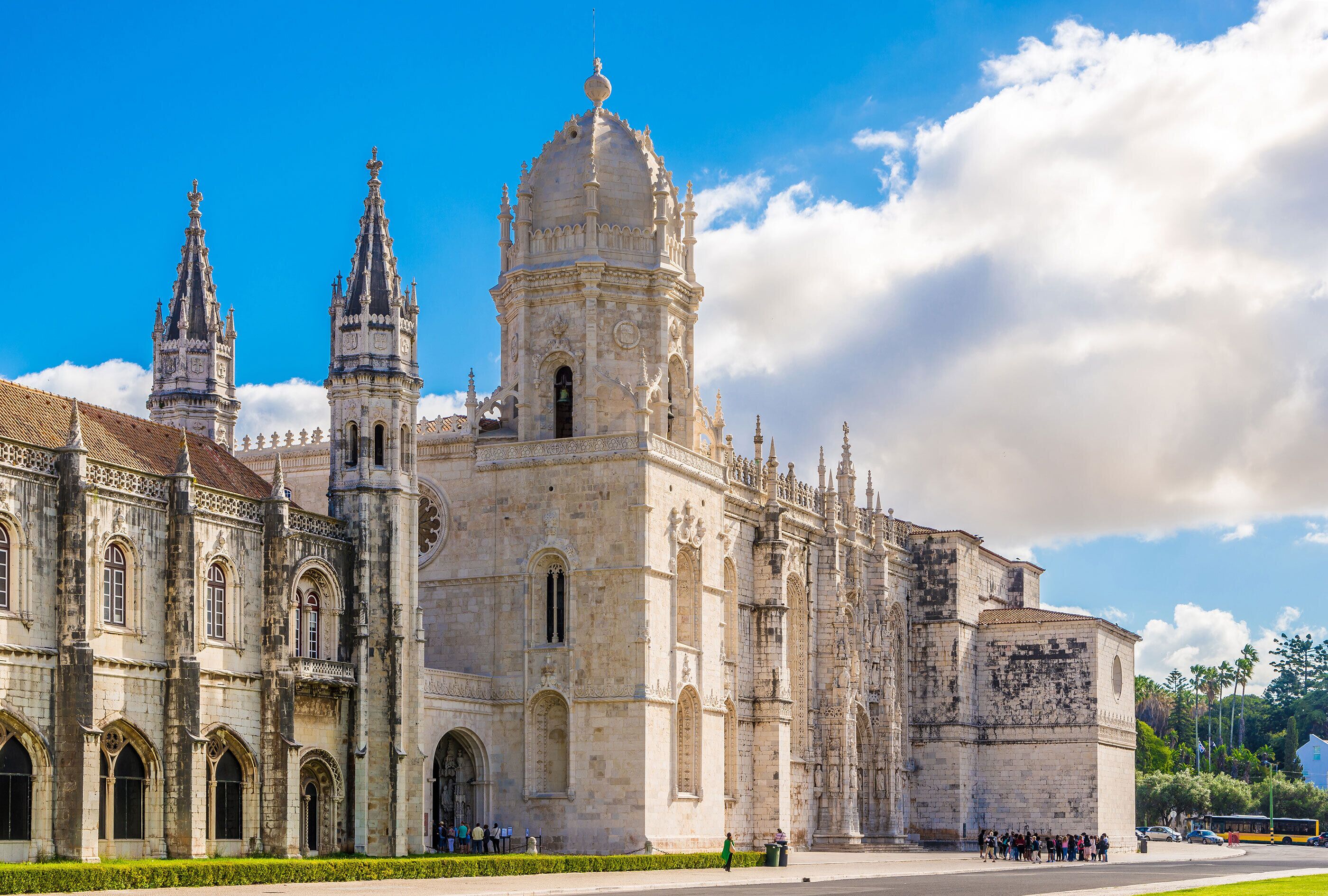 A historic cathedral with multiple spires and a large central dome, surrounded by a well-maintained courtyard.
